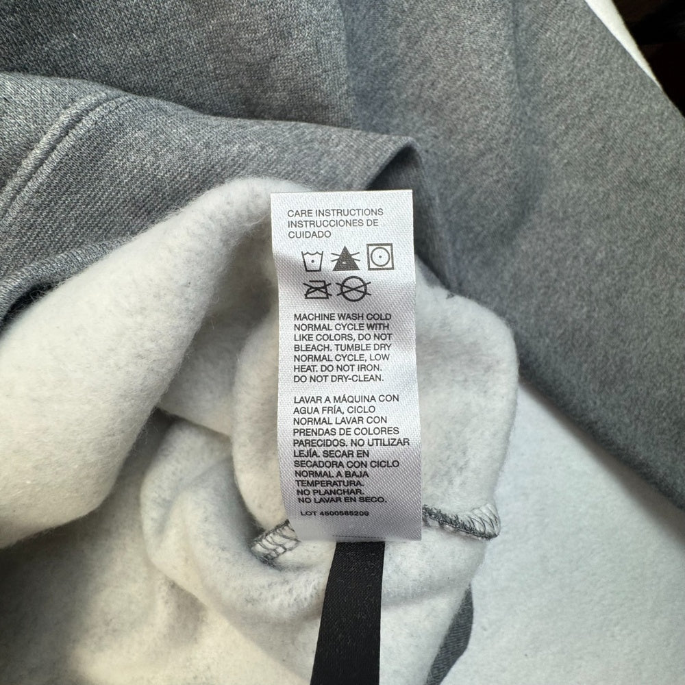 Clothing care label view of CAT gray hoodie size m