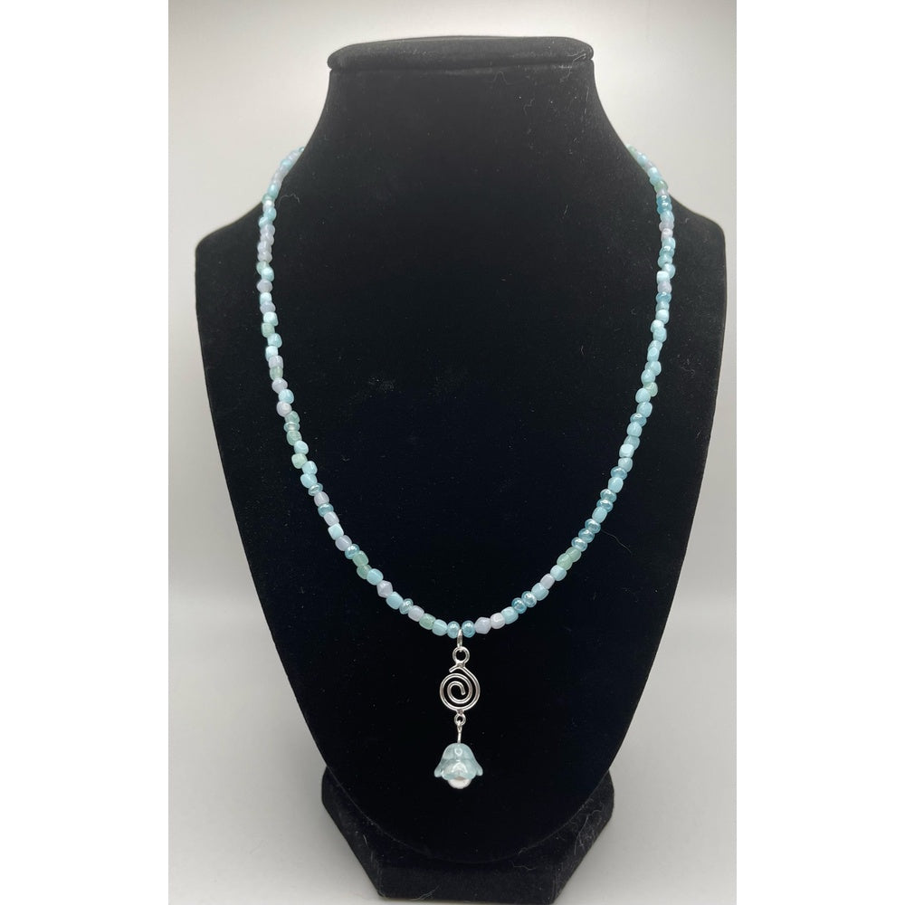Main View of handmade blue beaded necklace with a silver spiral pendant