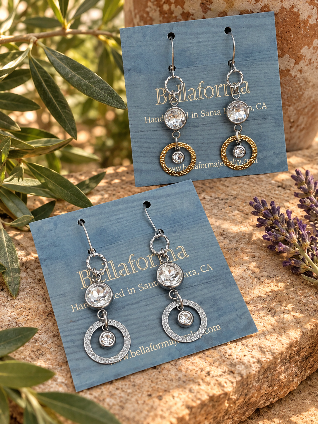 Venus Sunlight rhinestone dangle earrings displayed on Bellaforma Jewelry cards outdoors.