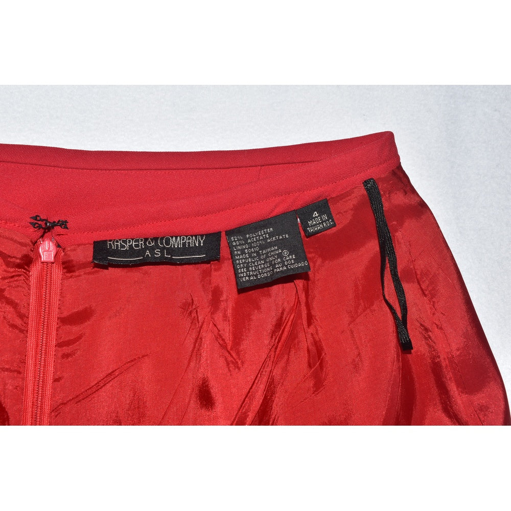 Clothing tags view on Kasper red skirt with a brand label on a white background