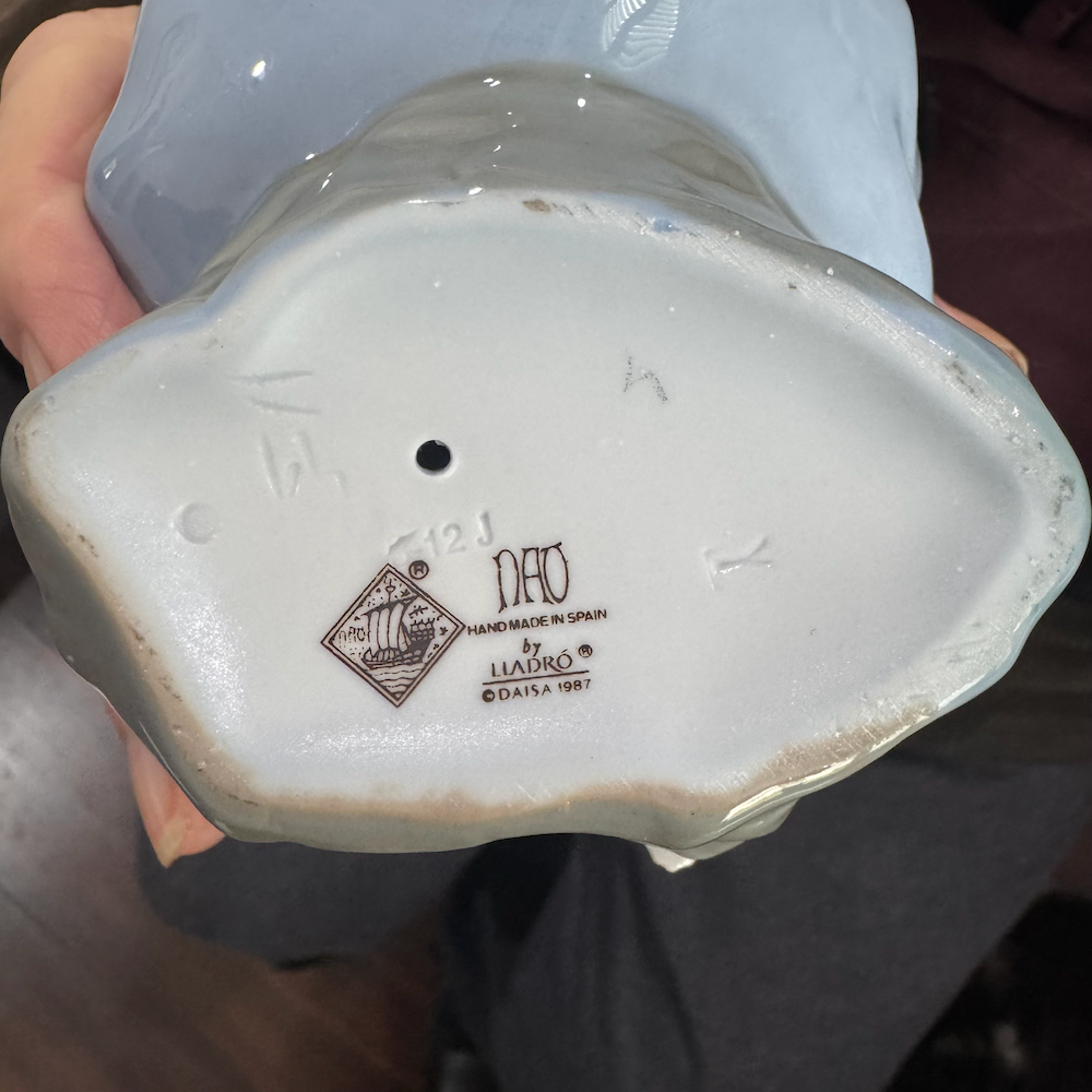 Creator stamp view of Lladro porcelain figurine listening to birds song