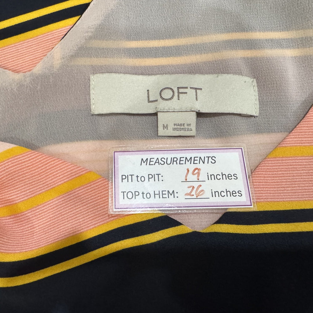 Clothing tag view of colorful striped fabric with a LOFT label and measurement tag.
