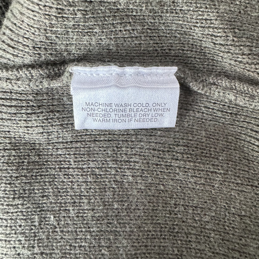 Clothing care tag on a Structure knit green sweater size L