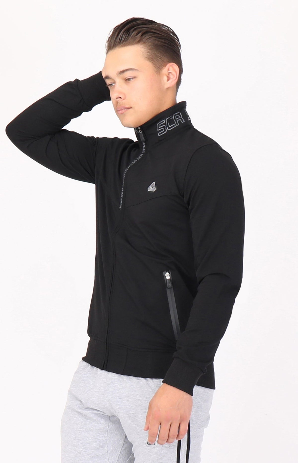 SCR Sportswear men's All-Day Comfort Full Zip Sweatshirt in black, featuring a stand-up collar, embroidered logo and zippered pockets, modeled front view.