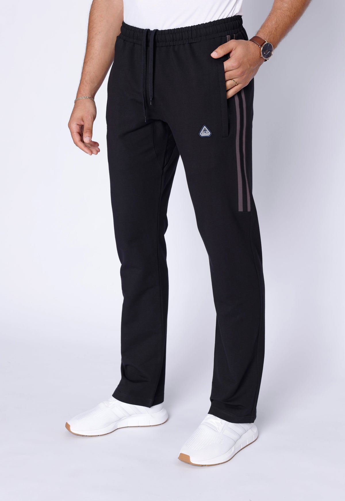 SCR Sportswear men's Ultimate Flex black straight-leg athletic sweatpants with adjustable drawstring waist, zippered pockets and side stripe detail.