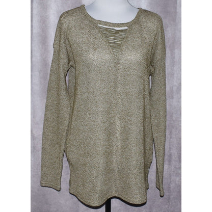 A long-sleeve knit tunic top in a heathered olive green and beige color, displayed on a mannequin torso against a textured gray backdrop.