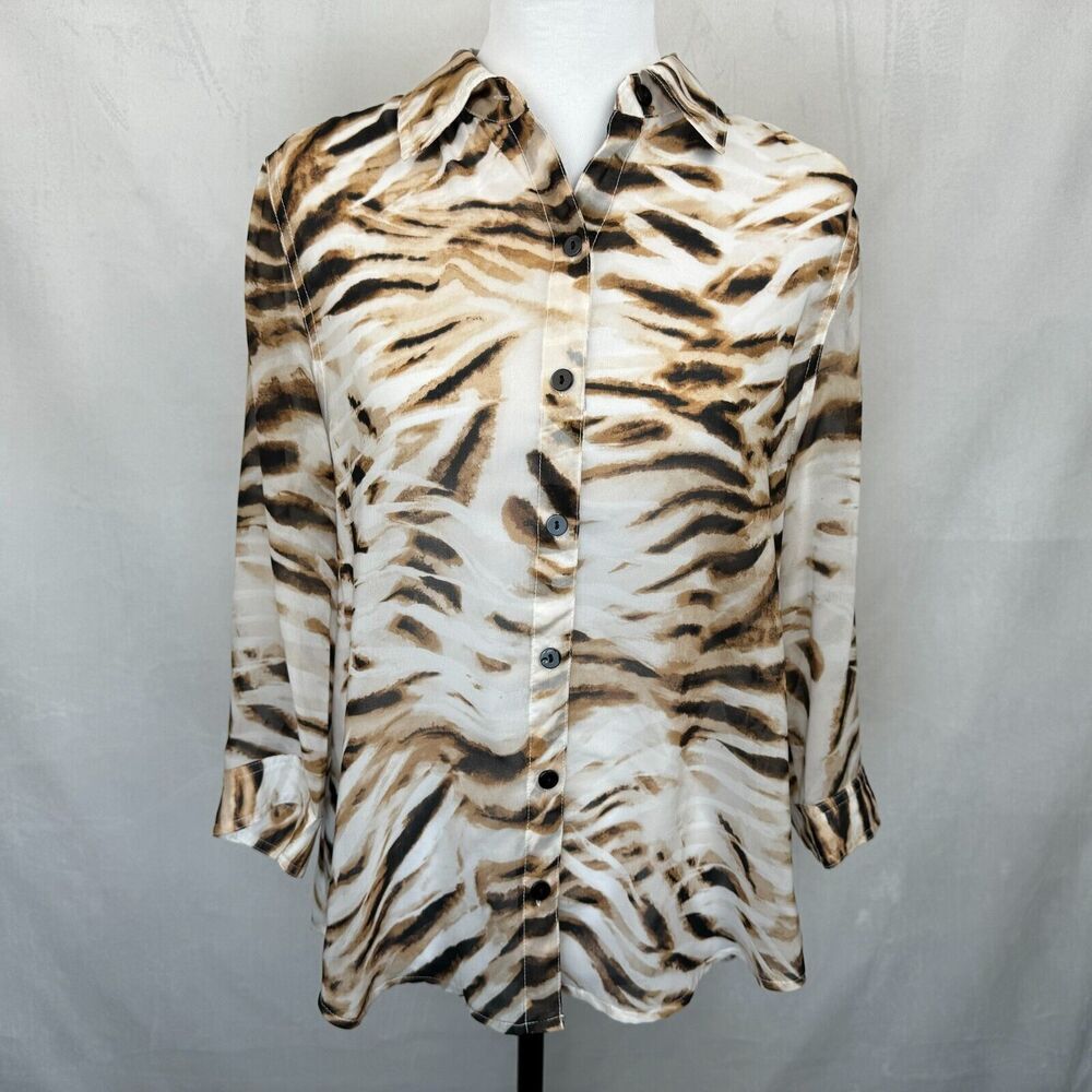 A long-sleeve button-up shirt with a brown and black tiger stripe pattern on a cream background, displayed on a white mannequin torso against a light gray fabric backdrop.