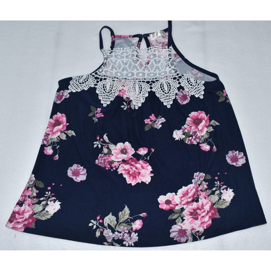 A sleeveless floral dress with a navy blue base, featuring pink and white rose patterns, a white lace-trimmed neckline, and thin shoulder straps, laid flat on a light gray background.