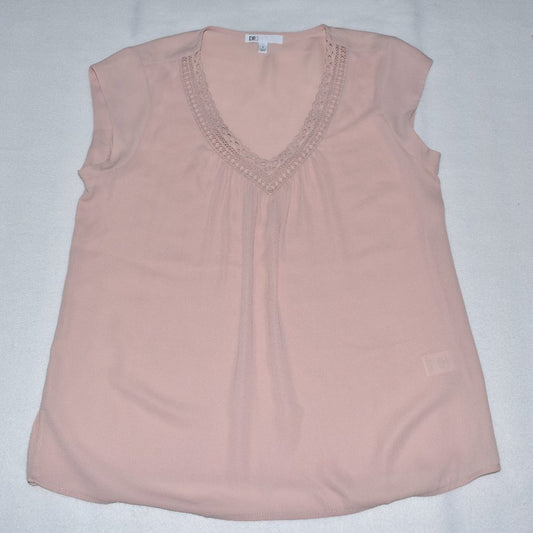 A light pink sleeveless top with a V-neckline and delicate lace trim, laid flat on a light gray background.