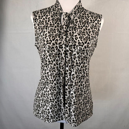 A sleeveless leopard-print blouse displayed on a white dress form against a light gray fabric backdrop.