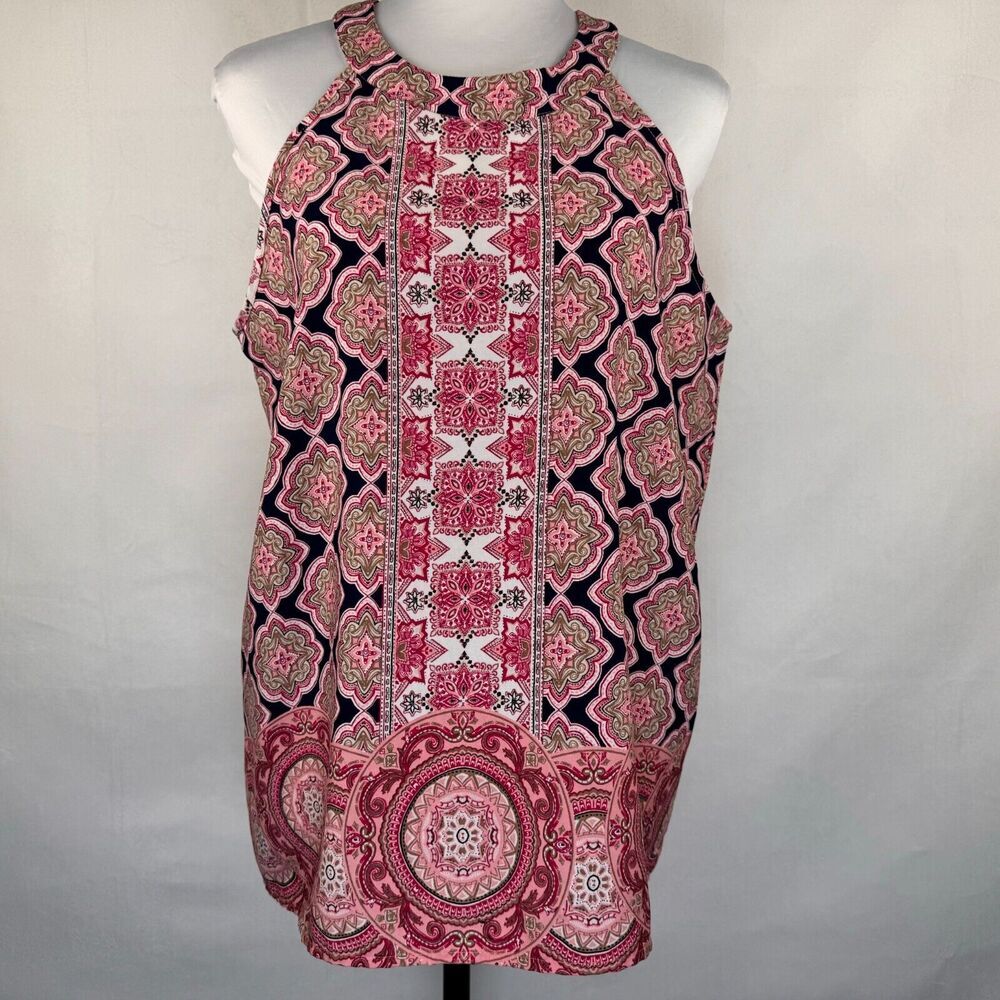 A sleeveless halter top with a pink, red, and black geometric and floral mandala pattern, displayed on a white mannequin torso against a light gray fabric backdrop.