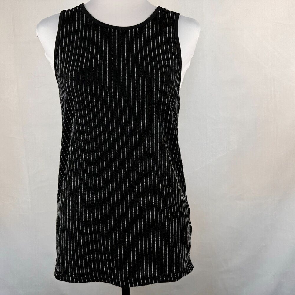 A sleeveless black knit top with vertical silver pinstripes, displayed on a white mannequin torso against a light gray fabric backdrop.