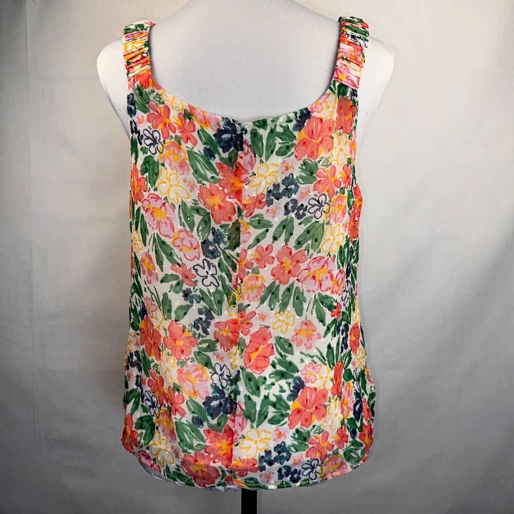 A sleeveless tank top with a vibrant multicolor floral print, displayed on a white mannequin torso against a light gray fabric backdrop.