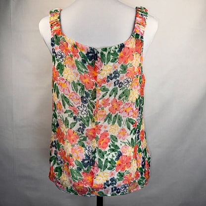 A sleeveless tank top with a vibrant multicolor floral print, displayed on a white mannequin torso against a light gray fabric backdrop.