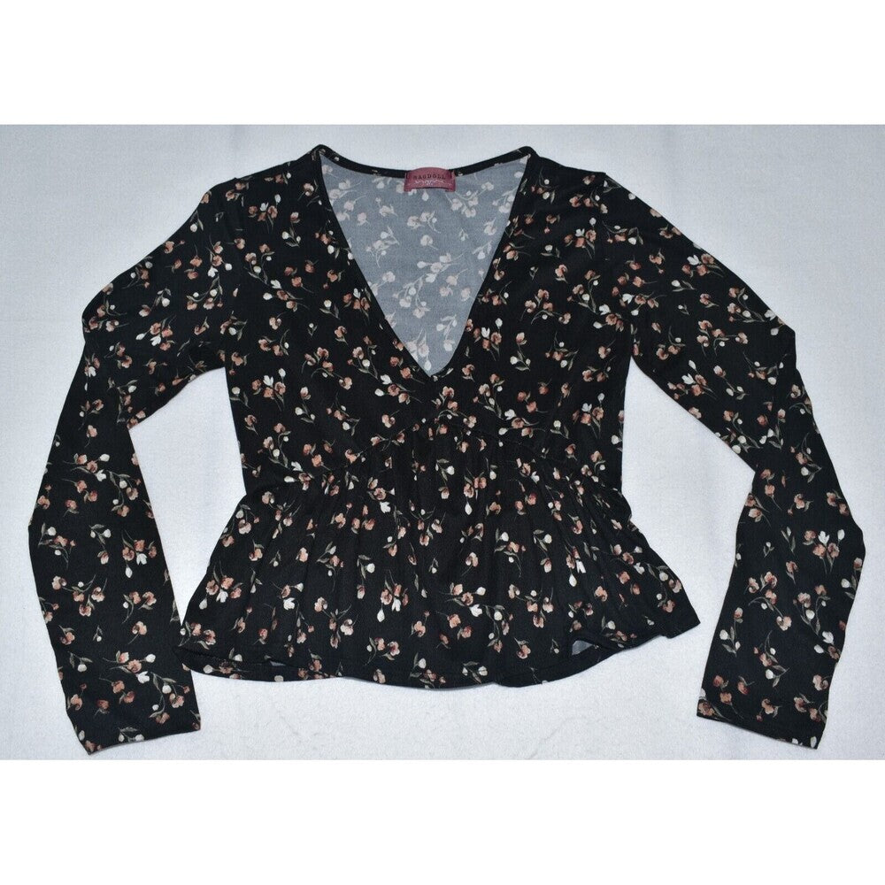 A women's long-sleeve wrap-style blouse with a V-neckline and peplum waist, featuring an all-over small floral print in brown, beige, and white on a black background.