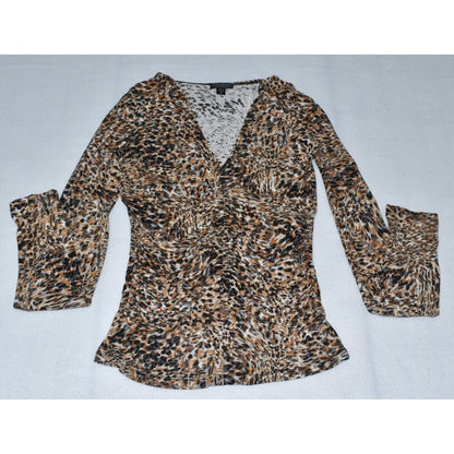A women's long-sleeve leopard print blouse with a V-neckline, laid flat on a light gray background.