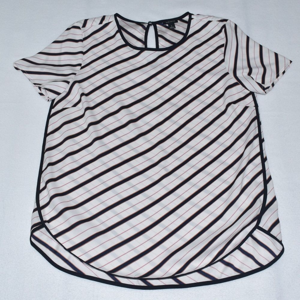 A short-sleeve blouse with diagonal black and thin red stripes on a white base, featuring a round neckline with a keyhole cutout at the back.