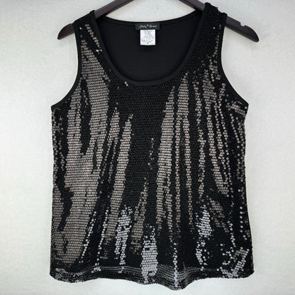 A black sleeveless knit top covered in vertical silver sequins, hanging on a dark hanger against a light textured wall.