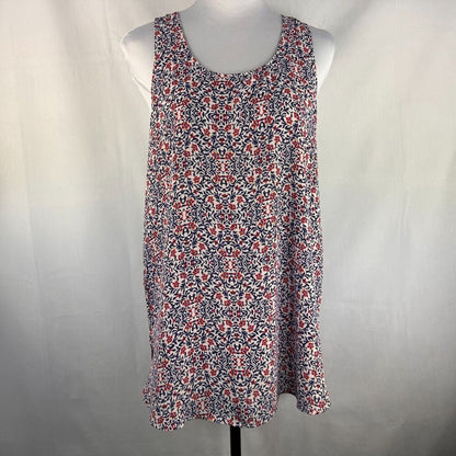A sleeveless scoop-neck shift dress with a dense red, white, and navy floral pattern, displayed on a white mannequin torso against a light gray fabric backdrop.