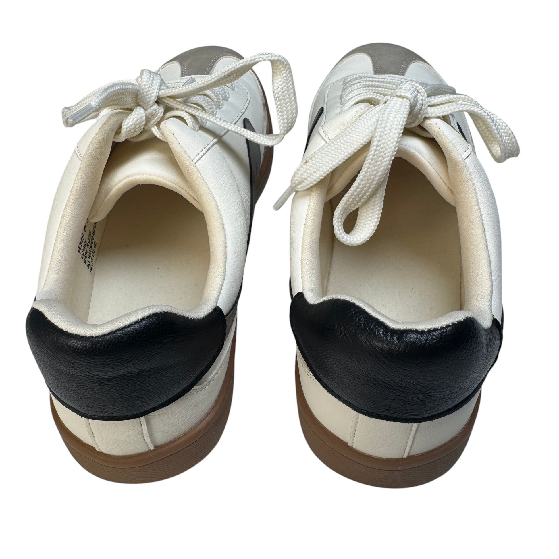 Black leather heel tab detail on Dolce Vita Voyage mixed-media sneakers.