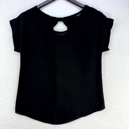 A black short-sleeve top with a keyhole cutout at the neckline, hanging on a dark hanger against a textured white wall.