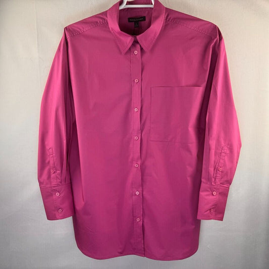 A bright pink long-sleeve button-down shirt with a single chest pocket, hanging on a white hanger against a light gray fabric backdrop.