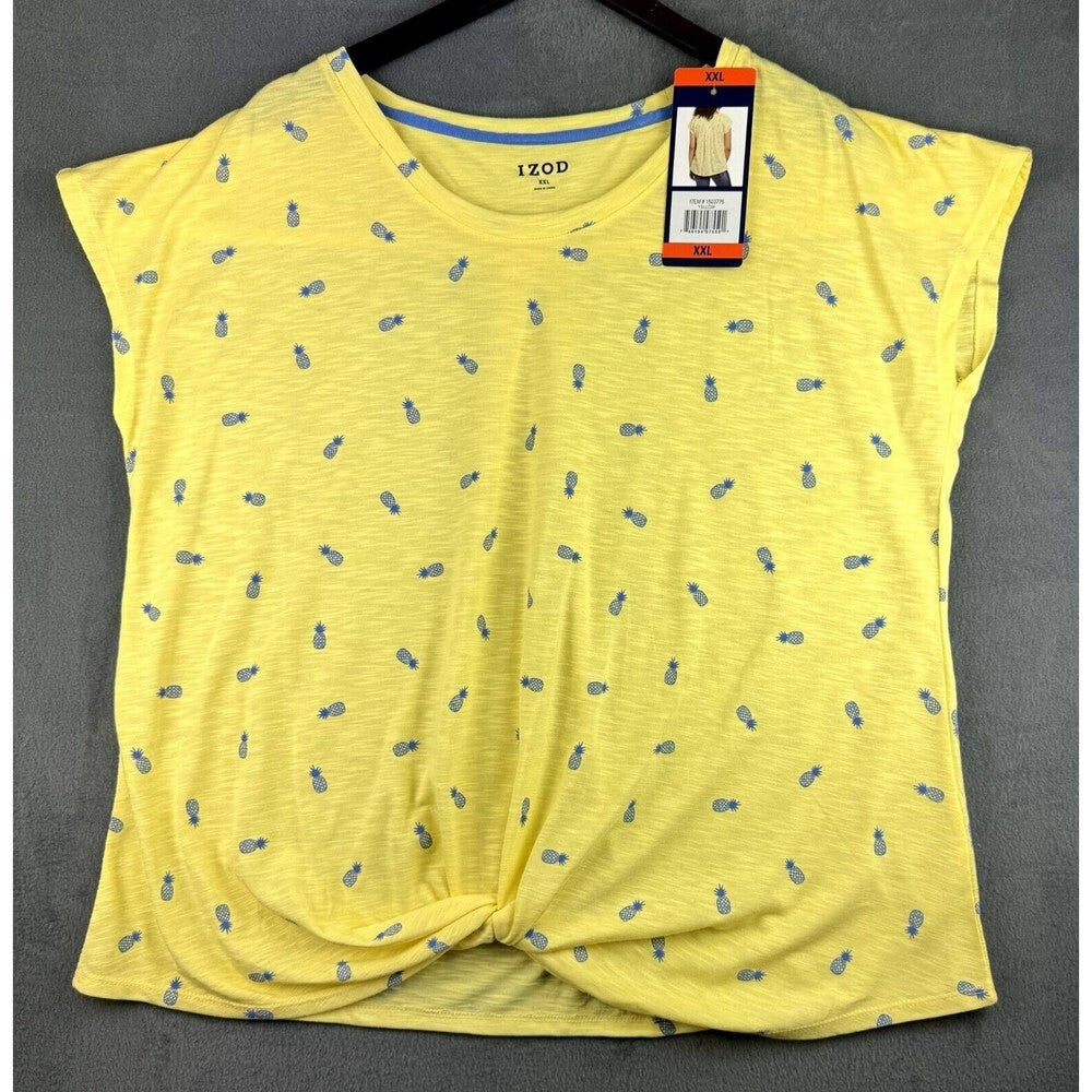 A yellow short-sleeve knit top with a small blue pineapple print all over, featuring a front twist detail and a visible hangtag.