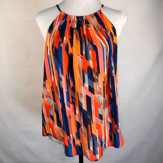 A sleeveless halter top with an abstract geometric print in orange, navy blue, pink, and white, displayed on a white mannequin torso against a light gray fabric background.