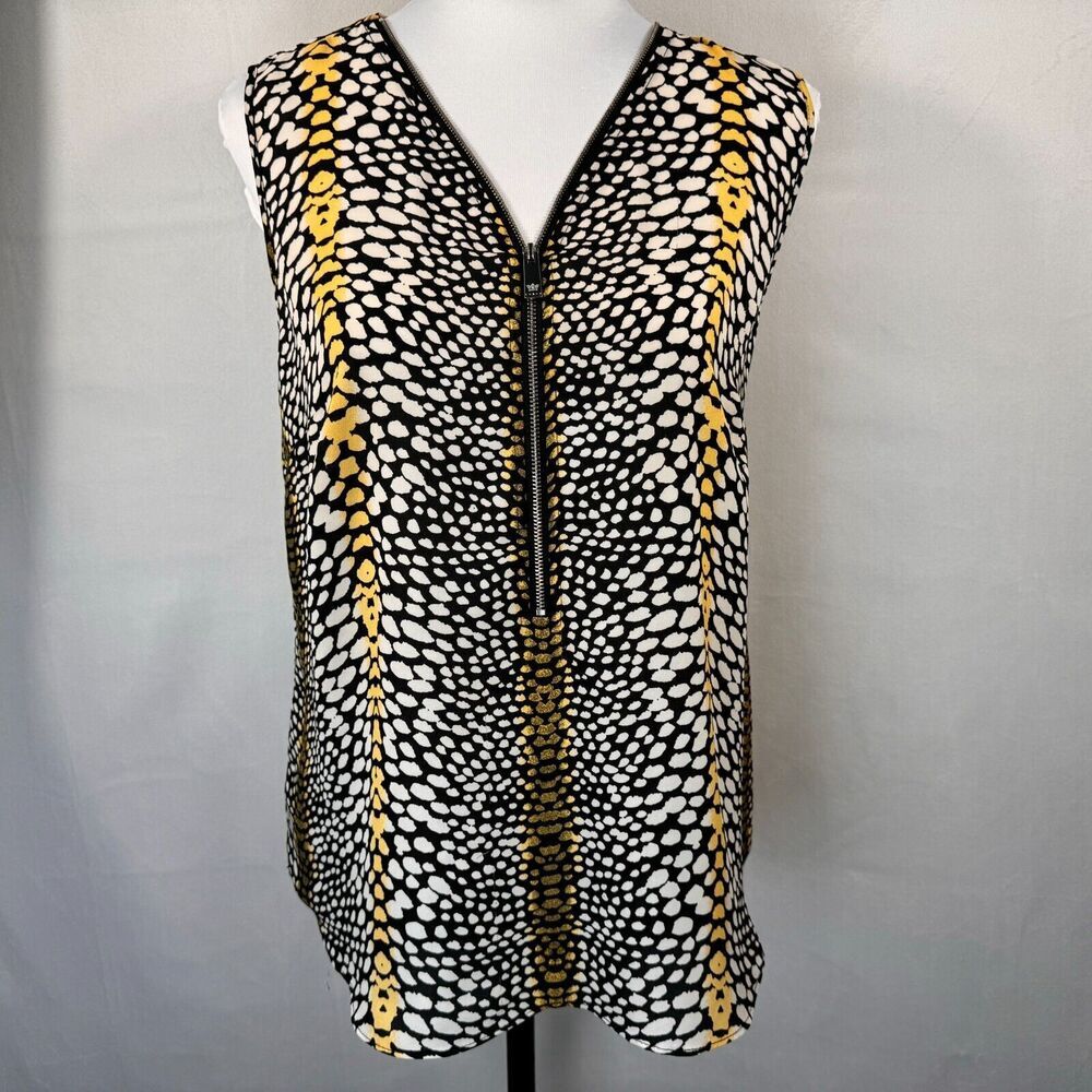 A sleeveless black vest with a white and yellow spotted pattern, featuring a front zipper, displayed on a white mannequin torso against a light gray background.