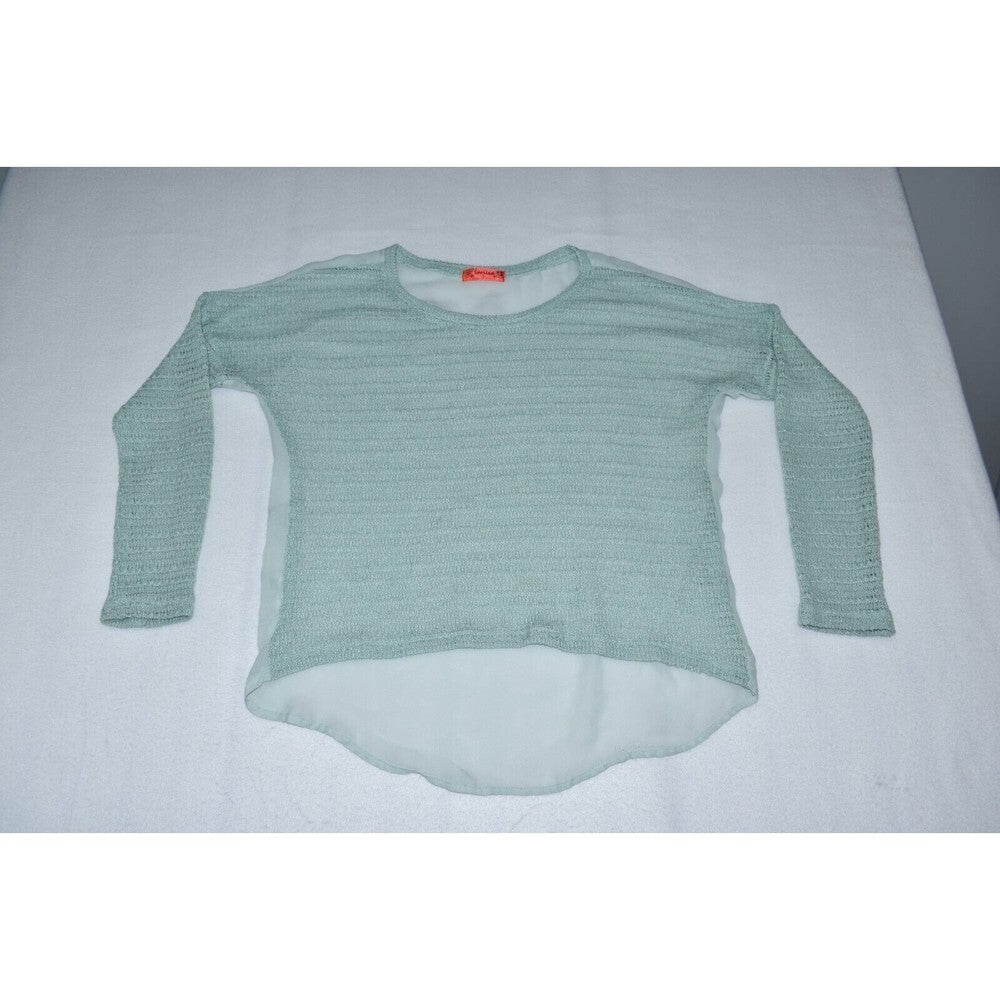 A light sage green ribbed knit long-sleeve top with a high-low hem, laid flat on a white surface.