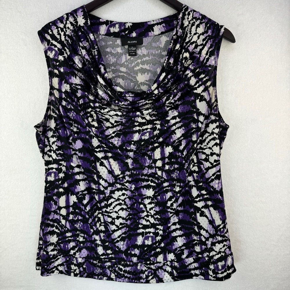 A sleeveless scoop-neck top with a purple, black, and white abstract tie-dye pattern, hanging on a black hanger against a white textured wall.