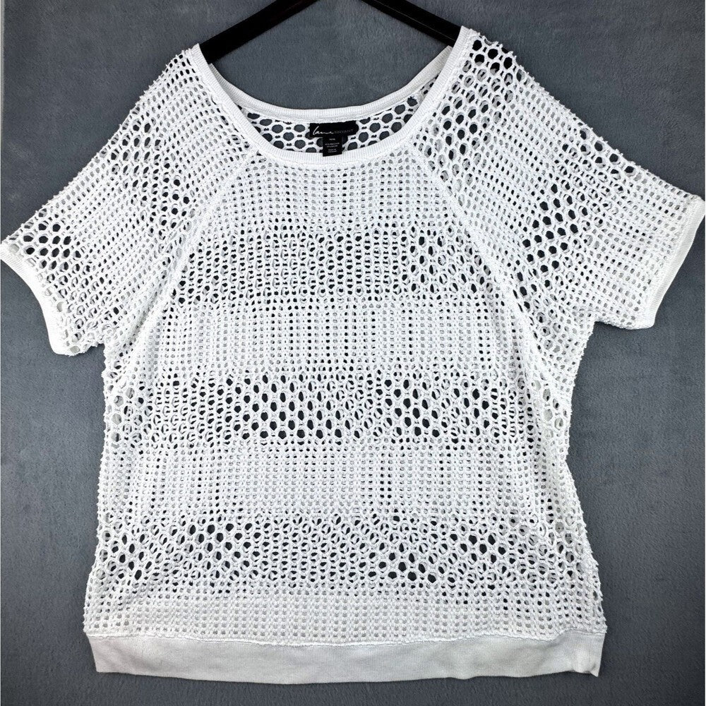White short-sleeve crochet knit top hanging on a black hanger against a dark gray background.