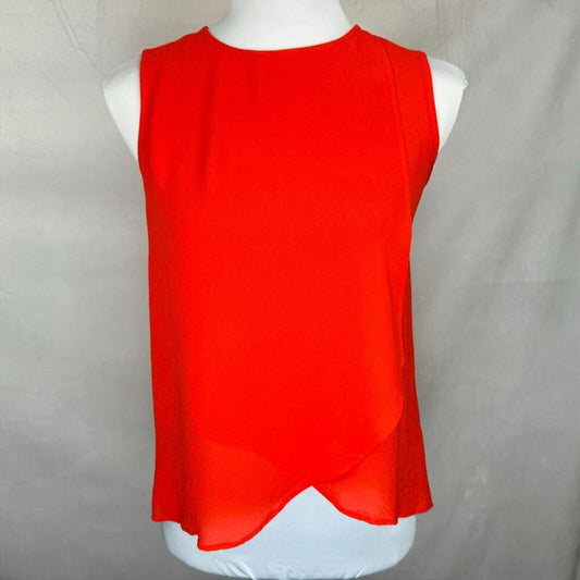 A bright red sleeveless top displayed on a white mannequin torso against a light gray fabric backdrop.