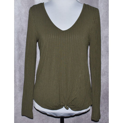 An olive green ribbed knit long-sleeve top with a V-neck and front knot detail, displayed on a white mannequin torso against a gray textured background.