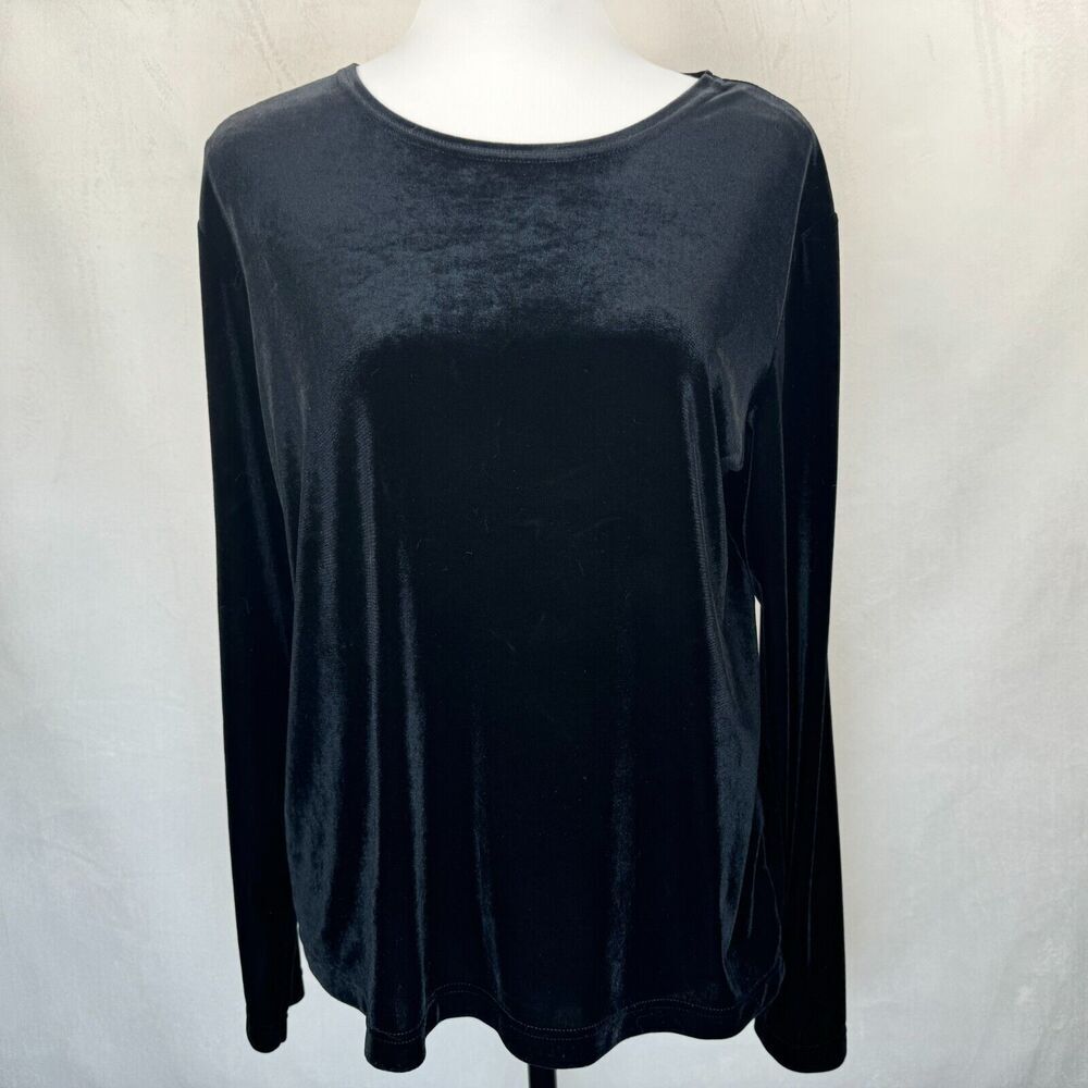 A black long-sleeve velvet top displayed on a white mannequin torso against a light gray fabric backdrop.