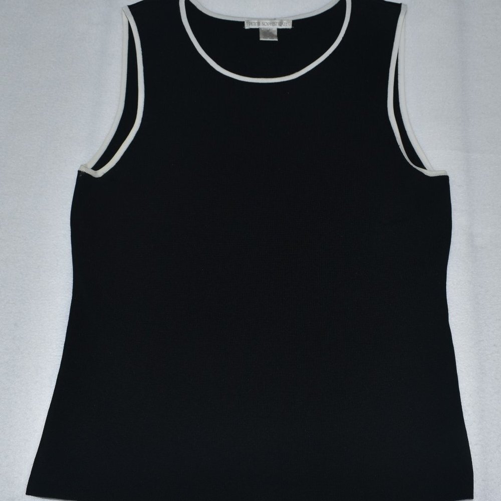A black sleeveless tank top with white contrast trim around the scoop neck and armholes, laid flat on a light gray background.