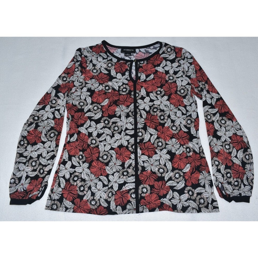 A long-sleeve button-front blouse with a black, red, and white floral pattern, laid flat on a light gray background.