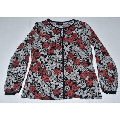 A long-sleeve button-front blouse with a black, red, and white floral pattern, laid flat on a light gray background.