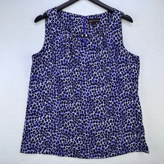 A sleeveless leopard-print top in shades of purple, blue, and black, hanging on a black hanger against a light gray textured background.