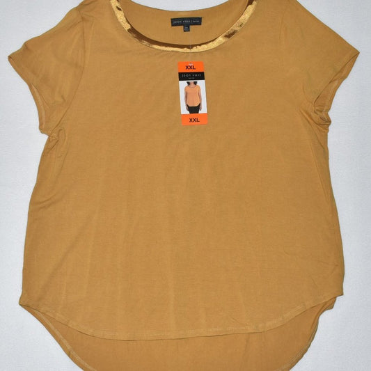 A women's mustard yellow short-sleeve top with a high-low hem, featuring a decorative gold patterned trim along the scoop neckline. The shirt is shown flat on a light gray background with its retail tag still attached.