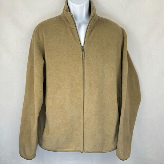 A tan zip-up fleece jacket displayed on a white mannequin torso against a light gray textured wall.