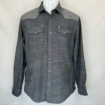 A dark gray western-style long-sleeve button-up shirt with a subtle textured weave, featuring a zippered chest pocket and two buttoned flap chest pockets, displayed on a white mannequin torso against a light gray background.