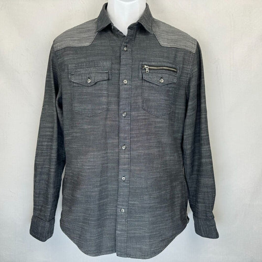 A dark gray western-style long-sleeve button-up shirt with a subtle textured weave, featuring a zippered chest pocket and two buttoned flap chest pockets, displayed on a white mannequin torso against a light gray background.
