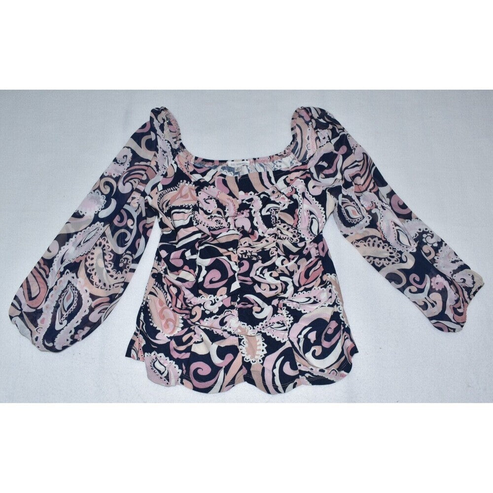 A women's long-sleeve blouse with a square neckline, featuring a swirling paisley-like abstract pattern in black, pink, and beige, laid flat on a light gray background.