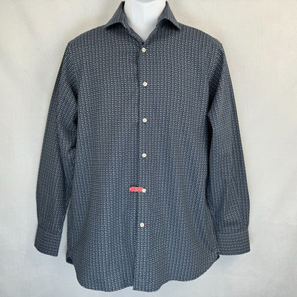 A long-sleeve button-up shirt with a small repeating geometric pattern in navy and white, displayed on a white mannequin torso against a light gray fabric backdrop.