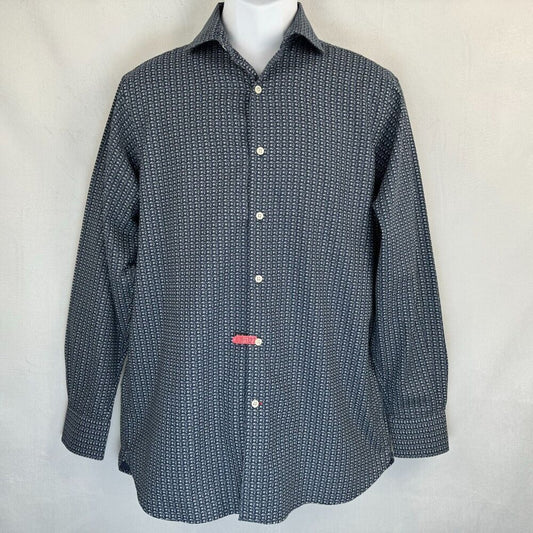 A long-sleeve button-up shirt with a small repeating geometric pattern in navy and white, displayed on a white mannequin torso against a light gray fabric backdrop.