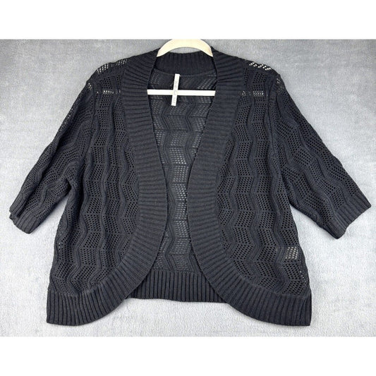 A black open-front knit cardigan sweater with three-quarter sleeves and a textured chevron pattern, laid flat on a light gray textured background.