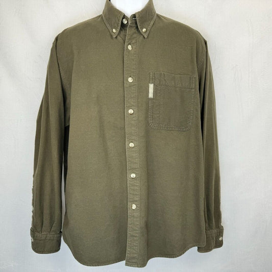 An olive green long-sleeve button-down shirt with a chest pocket, displayed on a white mannequin torso against a light gray fabric backdrop.