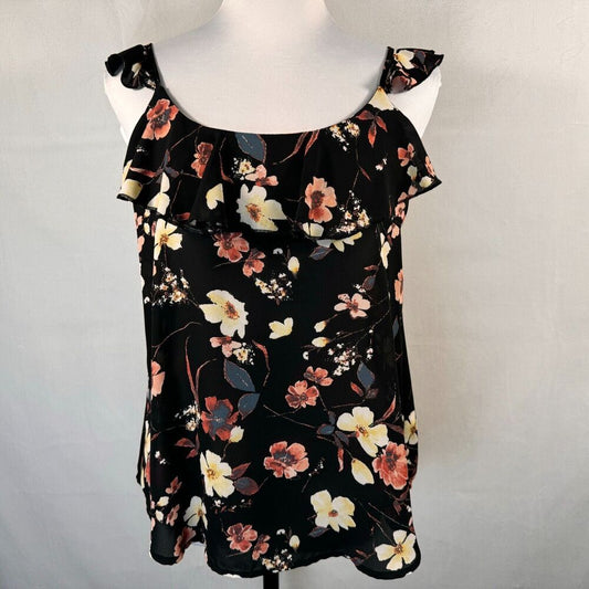 A black sleeveless top with a floral print, displayed on a white mannequin torso against a light gray background.