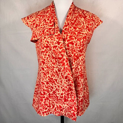 A red and beige leopard print wrap-style blouse displayed on a white mannequin torso against a light gray fabric backdrop.